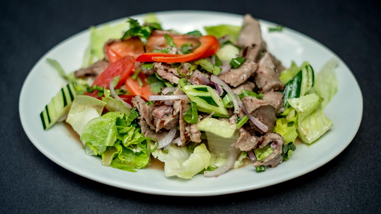 Yum Neua (Beef Salad) restaurant presentation; catering portions may differ